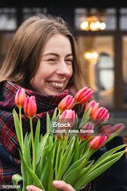 Happy Woman With Bouquet Of Flowers Waving Hello To Someone Spring Portrait  Stock Photo