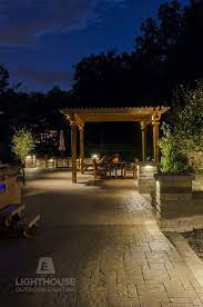 Low Voltage Lighting Set In The Walls And Pergola Of This Backyard Create An Inviting And Comfo Landscape Lighting Design Outdoor Lighting Led Outdoor Lighting