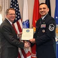 Service members line up before U.S. Secretary of Defense