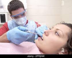 **ADVANCE FOR WEEKEND OF JAN. 4-6 ** Felicia Burnett sits in the chair as  acting dental assistant Gregory Schuster rinses the polish from her teeth,  Dec. 11, 2002, in Lynchburg, Va. Schuster is enrolled in the Dental Careers  program at E.C. Glass High ...