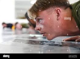 U. S. Marine Corps Lance Cpl. Garrett Stevenson, assigned to Fleet  Anti-Terrorism Security Team Company Europe (FASTEUR), warms up for an  exchange of martial arts techniques with the Spanish National Police's Grupo