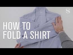 A Step By Step Guide On How To Fold A Dress Shirt And Pack In A Suitcase Or Carry On So It Doesn T Wrinkle Duri Suitcase Packing Shirt Folding Mens Shirt
