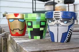 Hand Painted Clay Pots Featuring From Left To Right Ironman A Minecraft Creeper And Transformers P Painted Clay Pots Terra Cotta Pot Crafts Clay Pot Crafts