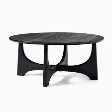 Brown medium round wood coffee table with plank design base. Tanner Solid Wood Black 40 Round Hemlock Coffee Table West Elm Havenly