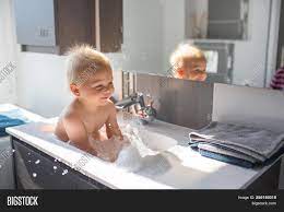 You can give your newborn a bath in a small plastic bath or even in the kitchen sink. Baby Taking Bath Sink Image Photo Free Trial Bigstock