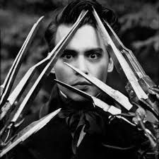 EDWARD SCISSORHANDS (1990) American romantic dark fantasy film directed by  Tim Burton, starring Johnny Depp as an artificial man named Edward, an  unfinished creation who has scissor blades instead of hands. Also
