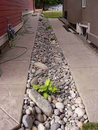 Stepping stone walkway & flagstone patio. River Rock Swale You Mine As Well Dress It Up Green Landscape Garden Drainage Yard Drainage