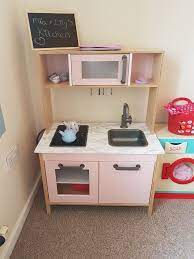 To pull it off, she used a mix of sherwin williams primer and paint, as well as some spray paint for the fixtures. Ikea Duktig Kitchen Make Over Using Rust Oleum Satin Finish Furniture Paint In Pink Champagne Amd Marble E Ikea Kids Kitchen Ikea Play Kitchen Diy Play Kitchen
