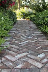 Stone paver walkway with herringbone pattern. Timeless Herringbone Pattern In Home Decor Outdoor Walkway Brick Pathway Brick Sidewalk