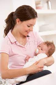 Mother Cuddling Baby Boy At Home | Stock Image | Colourbox