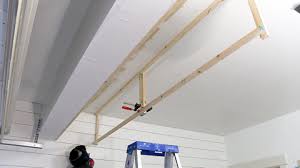 How about creating a suspended, sliding storage system where you could keep all your tools and other goodies? Ceiling Storage Diy Garage Remodel Ep 2 Paul Tran Diy