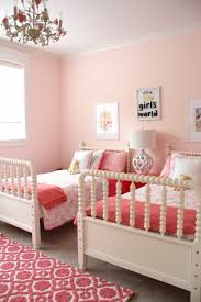 A stylish modern farmhouse shared teen bedroom with a plywood bunk bed, a desk, green ottomans and textiles. Monday Makeover Shared Little Girls Room
