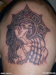 There are some black and grey inked tribal designs that cover the woman's face with some red swirls in the background. 45 Mysterious Aztec Tattoo Ideas Designs Photos Pictures Picsmine