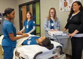 Clarksville Campus Machine Tool Technology students Brad Thomas (left) and  Jaydon Nicolodi (right) get advice