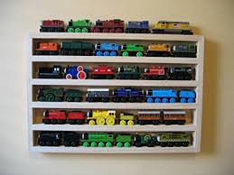 If your brother has wooden thomas trains, some are very rare, even if in used condition, and they can fetch $50 or more per train too on ebay. Train Rack Basic Thomas Train Wooden Storage Display Wall Rack Shelf Play Table Accessory Case For Brio Chuggington Melissa And Doug Buy Online In Antigua And Barbuda At Antigua Desertcart Com Productid