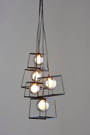 This multi light chandelier offers a black finish, exposed hardware and polished smoke glass shades. Next Cube 5 Light Cluster Pendant Black Cluster Pendant Lighting Ceiling Lights Ceiling Pendant Lights