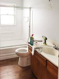 The dark trim color contrasts the creamy walls painted in the shade swiss coffee. How To Paint Tile The Easy Way Painting Tile Painting Bathroom Tiles Tile Bathroom