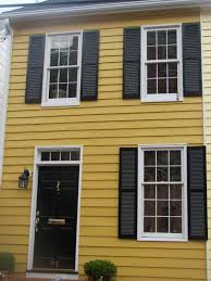 Blue house siding with gray trim gives familiar home styles (colonials or cape cods, for example) an updated twist. Dark Mustard Yellow Darker Than This White Trim Black Doors Shutters Warm Creamy Gray And Blac Yellow House Exterior White Exterior Houses Yellow Houses