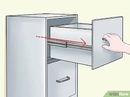 Look through the gap of the oven drawer and slide the spatula or ruler down into the drawer. 4 Ways To Remove Drawers Wikihow