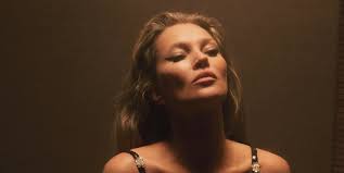 Kate Moss wearing a hooded sheer Saint Laurent gown