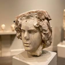 This is the portrait of Antinous, the Roman Emperor Hadrian's lover. One  day, Antinous mysteriously drowned in the Nile River leaving Hadrian  heartbroken. In his grief, Hadrian deified Antinous and commissioned many