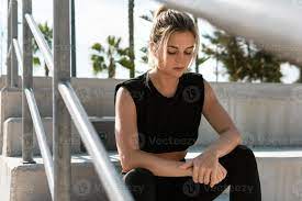 Athletic woman relaxing after summer street workout 16250129 Stock Photo at  Vecteezy