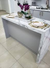 Featuring a wooden kitchen island with granite countertop, dual sink, breakfast top, chairspace, and storage, this kitchen is also in the unique position of facing a beautiful body of water. Luxury Kitchen Island Modern Design
