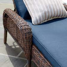 Relax poolside in a comfortable outdoor chaise lounge. Hampton Bay Cambridge Brown Wicker Outdoor Patio Chaise Lounge With Navy Blue Cushions 65 517148b The Home Depot Outdoor Patio Chaise Lounge Patio Chaise Lounge Wicker Chaise Lounge