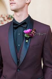 Black And Maroon Tuxedo Boutonniere Style Burgundy Shawl Lapel Tuxedo With A Black Shirt And Black Bow Tie With A Pink Floral Groomsmen Attire Black Groom Wedding Attire Black Wedding