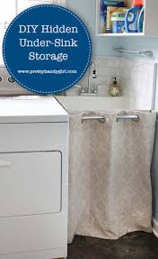 Why don't you hide them under a sink skirt? Hidden Storage Under A Laundry Room Sink