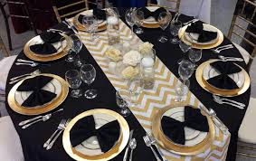 Black And Gold Table Black And Gold Table For Your New Years Party The Chevron Runner With The Gold Charger Pla New Years Eve Party New Years Eve Decorations Black And Gold Theme