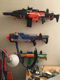 Used various hooks, wood screws, and nails to mount the guns. Nerf Gun Rack Nerf