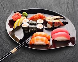 Sushi is served with a small dish of soy for dipping, and some sliced ginger. Japan National Dish Sushi