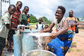 Community members gathering water from a borehole