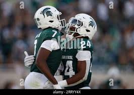 Michigan State's Antonio Gates Jr., left, celebrates with Davion Primm (24)  after his touchdown reception against Richmond during the second half of an  NCAA college football game, Saturday, Sept. 9, 2023, in
