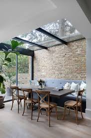 While interior brick walls often convey a sense of history, that certainly doesn't mean they can't also be elegant and contemporary. Conservatory Kitchen Extensions Transitional Dining Room London By Catherine Wilman Interiors Houzz
