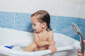 Keep baby soap, a bowl of warm water and a few washcloths handy. Beautiful Little Girl Taking A Bath At Home A Cute Baby Is Sitting In The Bathroom And Playing With Toys And Water Personal Hygiene For Children Daily Hygiene Stock Photo Picture And
