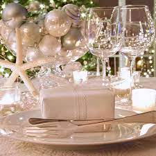 I wanted to look forward to the day, rather than dread it, so my husband and i planned a dinner party with some close friends to celebrate. Elegantly Lit Holiday Dinner Table With Wine Glasses And White Ribboned Gift Woking Sam Beare Hospices