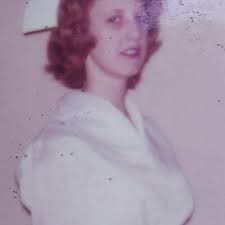 Damaged portrait of Mattie Edwards wearing plaid collared jacket with plaid  cuffs and embroidered scoop neck blouse seated at table. (1920) I repaired  what I could, but the glass plate was cracked