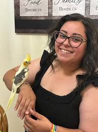 Monse of Yuma, AZ, with her new family member, a sweet handfed pied colored  baby cockatiel.