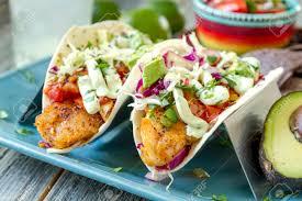 Line baking sheet with parchment paper and set aside. Fresh Fish Tacos With Coleslaw Avocado Salsa And Lime Creme In A Flour Tortilla On Blue Plate Stock Photo Picture And Royalty Free Image Image 73932900