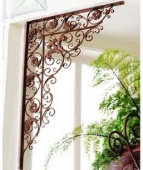 This metal scroll design of this wall art makes reference to the meridians of the earth. 7 Metal Scroll Art Above Windows Doors Beb Ideas Wrought Iron Decor Iron Decor Wrought Iron Design