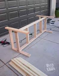 This outdoor bench has three wooden crates underneath the seating area, which is perfect for any storage needs. Diy Front Porch Bench
