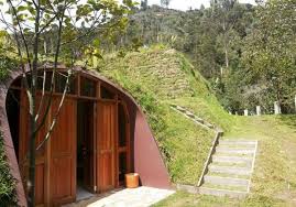 This Countryside Is Filled With Underground Doors That Lead To Tiny Hobbit Houses Green Magic Homes Earth Sheltered Homes Underground Homes