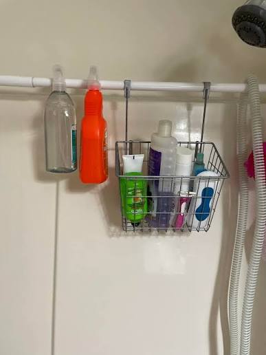 Hang an extra shower curtain rod across the back of the tub to hold supplies