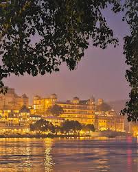 Experience the captivating charm of Udaipur at night, where serene lakes and majestic palaces glow under the starry sky, creating an enchanting atmosphere that will leave you spellbound. Tag & Share your