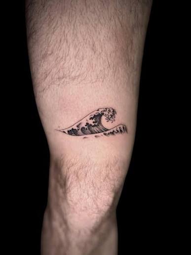 This fine-line wave tattoo captures the balance between chaos and serenity, a symbol of resilience, freedom, and the ever-changing flow of life. Inspired by traditional Japanese wave art, it's a minimalist yet