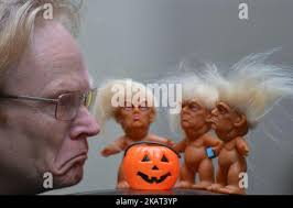 Gallery owner Frank O'Dea with a vinyl doll which features President Donald  Trump, made by a former sculptor for Disney, Chuck Williams. Donald Trump  Troll dolls can be seen and bought at