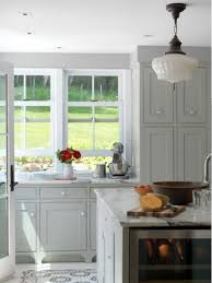 Here, the dark tone of the natural wood island provides contrast to the soft grayness of the room. Kitchen Design Ideas Grey Kitchen Designs Kitchen Remodel Light Grey Kitchen Cabinets