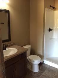 (us) a bathroom with a toilet, sink, and shower stall but without a bathtub. Mariah Three Quarter Bath Progressive Builders